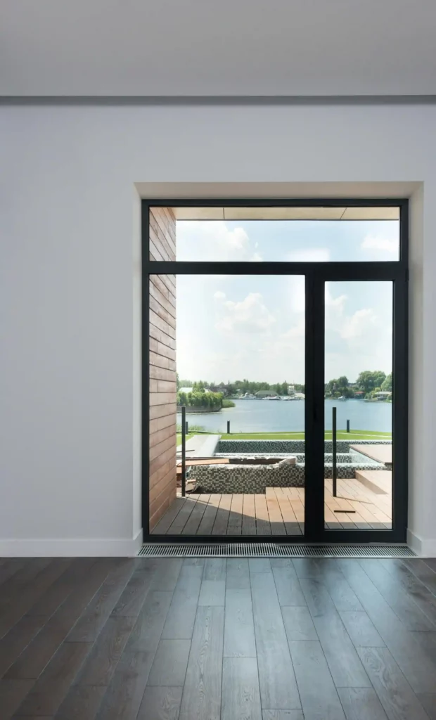 a glass door with a view of water and a deck